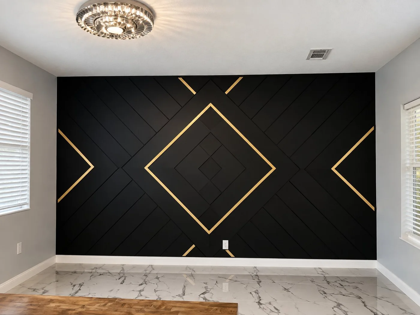 Black geometric accent wall with gold inlay details