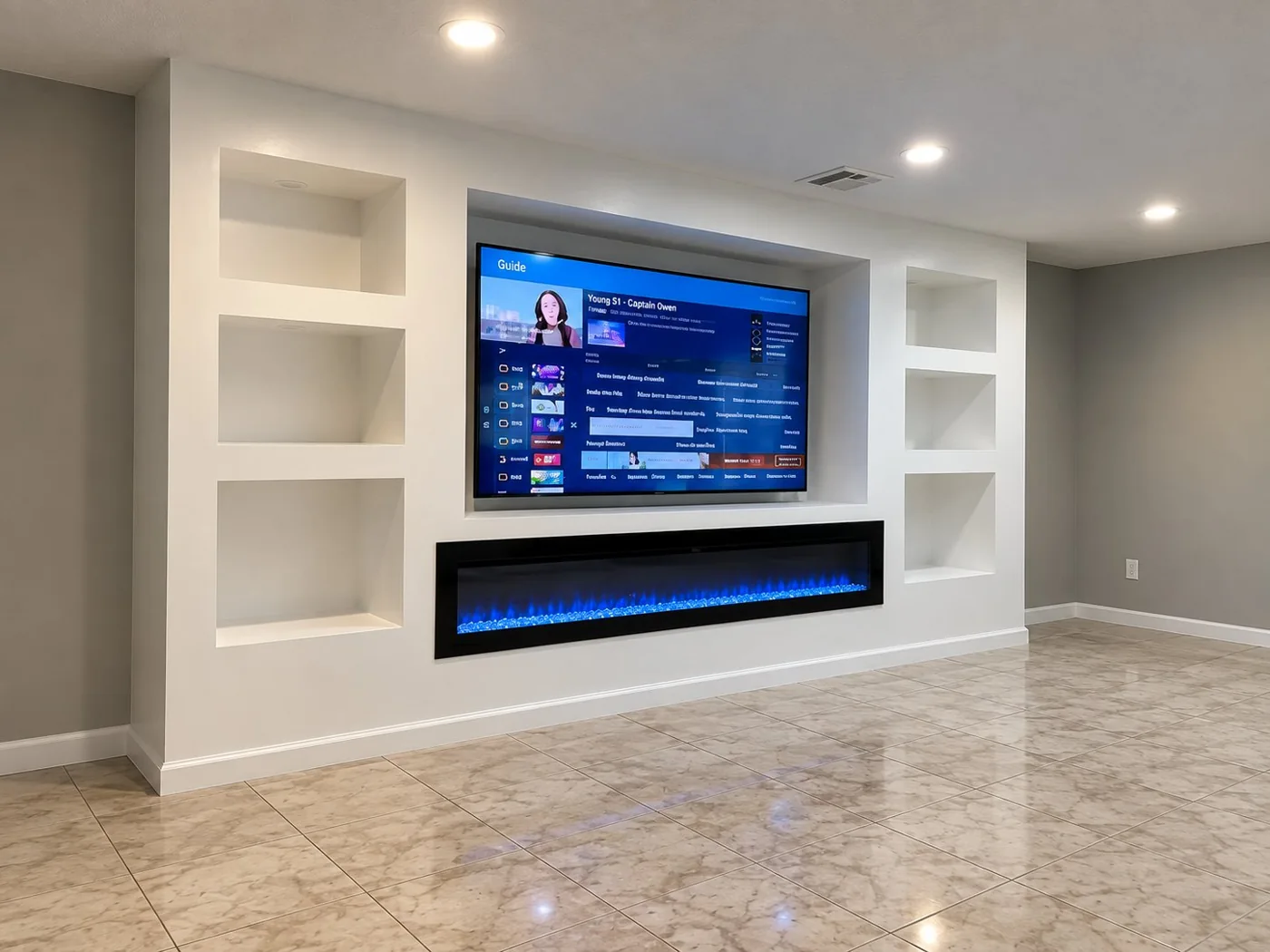 White built-in TV and electric fireplace feature wall with display niches