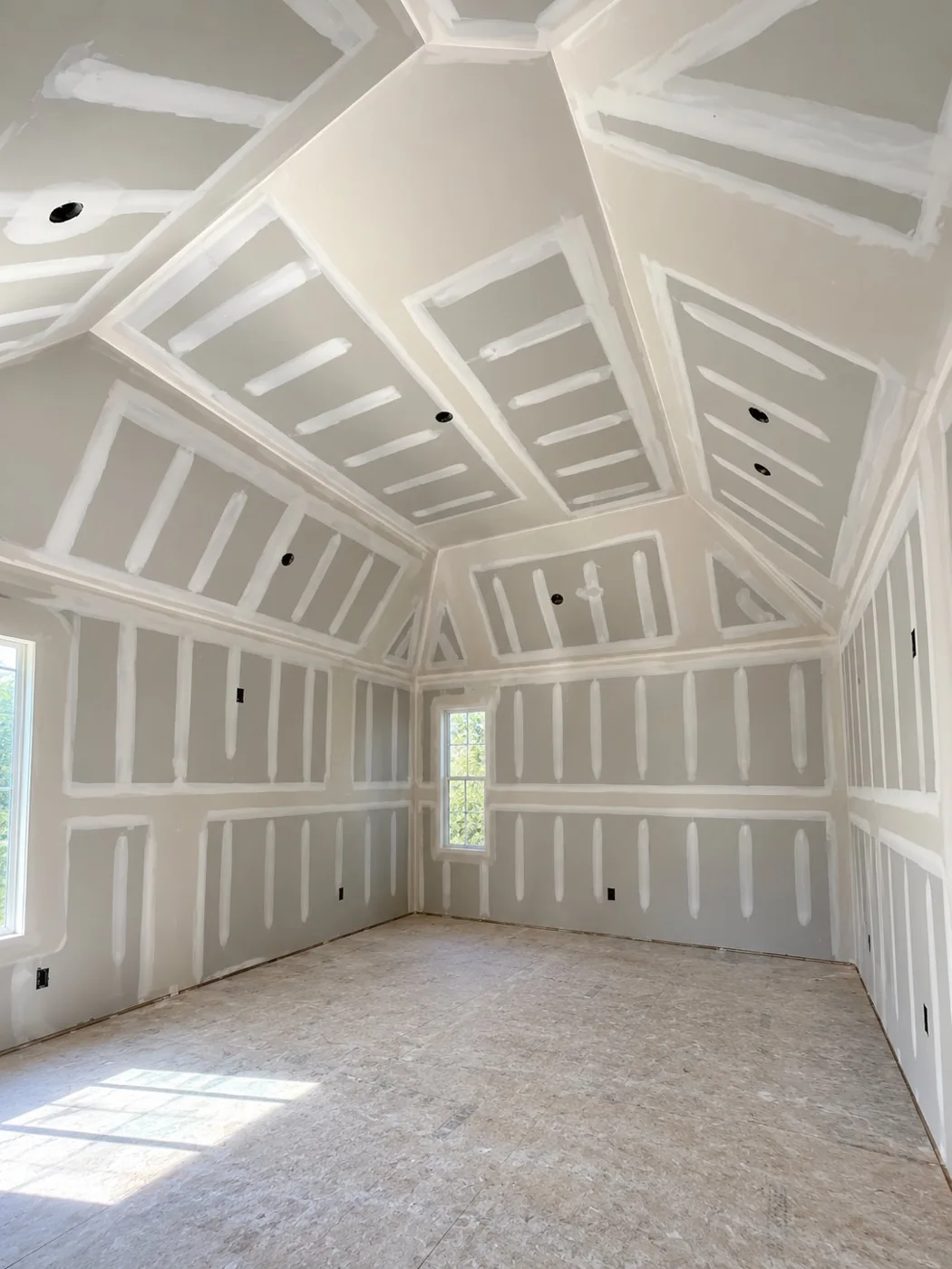 Drywall installation and finishing on a high vaulted decorative ceiling